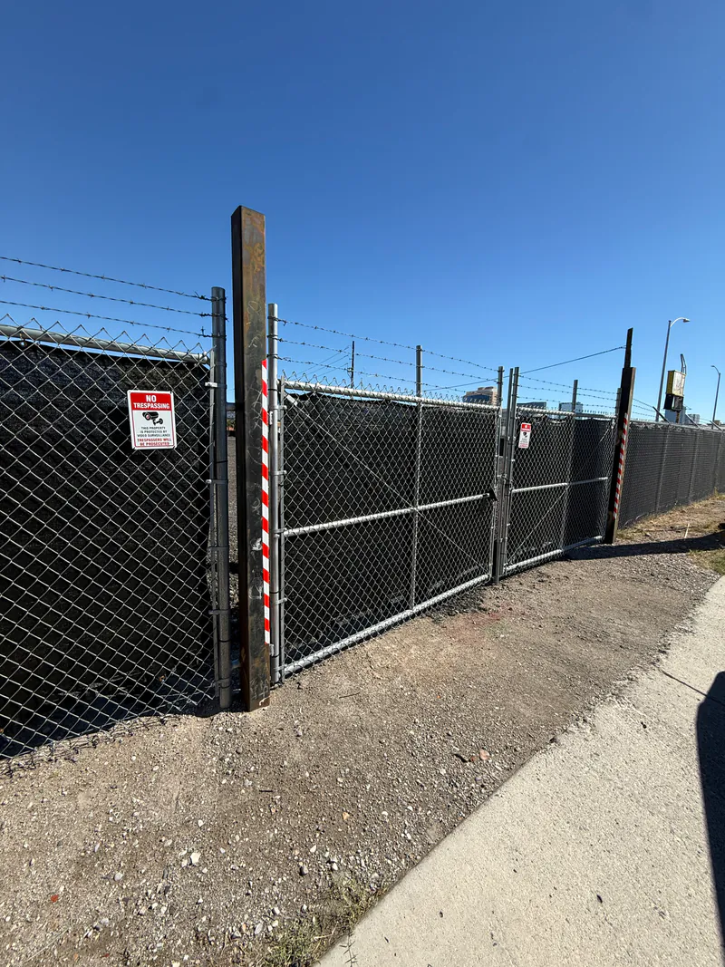 Locked security gate with no-trespassing signage at the Personal Storage Lot for RV, boat and trailer storage in Las Vegas